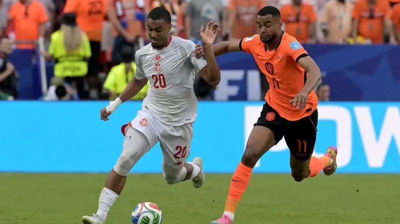 Tunisia's defender Yan Valery and Netherlands' forward #11 Cody Gakpo fight for the ball during the 2026 World Cup Group F football match between Tunisia and the Netherlands.
