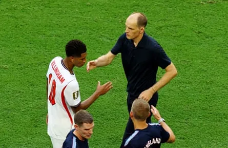 Thomas Tuchel goes to shake hands with Jude Bellingham as he is substituted against Norway.