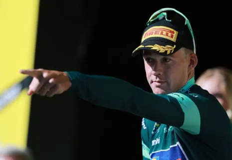 Lidl - Trek's Mads Pedersen celebrates on the podium wearing the green jersey after stage 19.